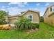 Charming single-Gathering home with a lush lawn and colorful flowerbeds at 6467 Seasound Dr, Apollo Beach, FL 33572