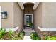 Beautiful front entryway with a decorative door, stone accents, and well-maintained landscaping at 6467 Seasound Dr, Apollo Beach, FL 33572