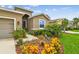 Charming single-Gathering home with colorful flowerbeds and an arched entryway at 6467 Seasound Dr, Apollo Beach, FL 33572