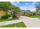Charming single-Gathering home with a lush lawn and colorful flowerbeds lining the driveway at 6467 Seasound Dr, Apollo Beach, FL 33572