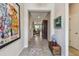 Long hallway with decorative painting and artwork leading to the living area at 6467 Seasound Dr, Apollo Beach, FL 33572