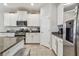 Well-equipped kitchen boasts stainless steel appliances and white cabinetry at 6467 Seasound Dr, Apollo Beach, FL 33572