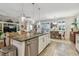 Open concept kitchen with island seating, pendant lights, and views of dining area at 6467 Seasound Dr, Apollo Beach, FL 33572