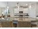 Stylish kitchen island with granite countertops, pendant lights, and wicker seating at 6467 Seasound Dr, Apollo Beach, FL 33572