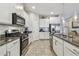Modern kitchen with stainless steel appliances, granite counters, and subway tile backsplash at 6467 Seasound Dr, Apollo Beach, FL 33572