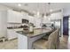 Kitchen island with granite countertops, seating, and modern appliances at 6467 Seasound Dr, Apollo Beach, FL 33572