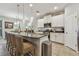 Modern kitchen featuring a spacious island with pendant lighting and seating at 6467 Seasound Dr, Apollo Beach, FL 33572