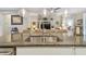 Granite kitchen island featuring a stainless steel sink and stylish pendant lighting at 6467 Seasound Dr, Apollo Beach, FL 33572