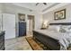 Comfortable bedroom features a large bed, tiled floor and artwork at 6467 Seasound Dr, Apollo Beach, FL 33572