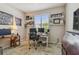 Functional home office with dual monitors, window with blinds, and decorative shelving at 6467 Seasound Dr, Apollo Beach, FL 33572