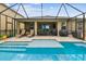 A relaxing screened-in pool and patio area with ample lounging space and outdoor cooking facilities at 6467 Seasound Dr, Apollo Beach, FL 33572