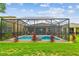 Beautiful screened-in pool with landscaped surroundings offers a private and serene outdoor space at 6467 Seasound Dr, Apollo Beach, FL 33572