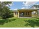 Backyard view showcasing a covered patio and fenced-in yard at 6706 Riverside Bluffs Dr, Riverview, FL 33578
