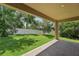Covered patio overlooking fenced-in backyard with mature trees at 6706 Riverside Bluffs Dr, Riverview, FL 33578