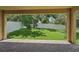 Covered patio overlooking fenced-in backyard with mature trees at 6706 Riverside Bluffs Dr, Riverview, FL 33578