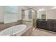 Modern bathroom with soaking tub and glass-enclosed shower at 6706 Riverside Bluffs Dr, Riverview, FL 33578
