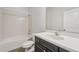 Bathroom featuring a bathtub with shower, a dark vanity, and neutral walls at 6706 Riverside Bluffs Dr, Riverview, FL 33578