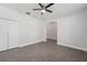 Bright bedroom with a ceiling fan, an arched doorway, tiled floor, and a large closet at 6706 Riverside Bluffs Dr, Riverview, FL 33578