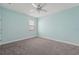 Cozy bedroom with soft carpet, light blue walls, and a window providing natural light at 6706 Riverside Bluffs Dr, Riverview, FL 33578