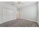 Bedroom with gray carpet, a ceiling fan, a closet, and light gray walls at 6706 Riverside Bluffs Dr, Riverview, FL 33578