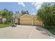 Inviting home featuring a three-car garage, manicured landscaping, and a basketball hoop in the driveway at 6706 Riverside Bluffs Dr, Riverview, FL 33578