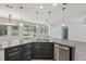 Modern kitchen features granite countertops, stainless steel appliances, and backyard view at 6706 Riverside Bluffs Dr, Riverview, FL 33578