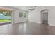 Well-lit living area with tile floors, offering seamless access to the outdoors through sliding glass doors and easy access to other rooms at 6706 Riverside Bluffs Dr, Riverview, FL 33578