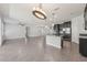 Spacious open-concept living room and kitchen features tile flooring and modern light fixtures at 6706 Riverside Bluffs Dr, Riverview, FL 33578