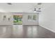 Comfortable living room with tile floors, sliding glass doors, and a ceiling fan, ideal for relaxing or entertaining guests at 6706 Riverside Bluffs Dr, Riverview, FL 33578