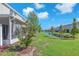 Enjoy the serene water views from this lush backyard featuring a covered, screened-in patio for outdoor relaxation at 7124 Summer Holly Pl, Riverview, FL 33578