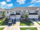 Beautiful townhome featuring a well-manicured lawn, a private garage, and neutral toned facade at 7124 Summer Holly Pl, Riverview, FL 33578
