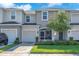 Charming townhome with a well-manicured lawn, blue front door and a one car garage at 7124 Summer Holly Pl, Riverview, FL 33578