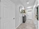 Hallway with tile floors, white walls, and access to multiple rooms at 7124 Summer Holly Pl, Riverview, FL 33578