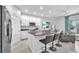 Open kitchen with granite countertops, stainless steel appliances, and an island with bar seating at 7124 Summer Holly Pl, Riverview, FL 33578