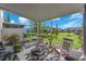 Screened lanai with comfortable seating and view of the lush backyard, perfect for relaxing outdoors at 7124 Summer Holly Pl, Riverview, FL 33578