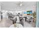 Bright open-concept living area with modern decor, including a sleek kitchen and dining space, with tile floors at 7124 Summer Holly Pl, Riverview, FL 33578