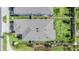 Aerial view of a well-maintained house with a gray roof, manicured lawn, and landscaped yard, conveying a sense of care at 7517 Notched Pine Bnd, Wesley Chapel, FL 33545