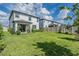 Large backyard with a patio and privacy fence offers plenty of outdoor living space at 7517 Notched Pine Bnd, Wesley Chapel, FL 33545
