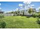 Spacious backyard features a well-maintained lawn and a white vinyl fence at 7517 Notched Pine Bnd, Wesley Chapel, FL 33545