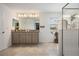 Bright bathroom featuring tile floors, double sinks, and a glass-enclosed shower at 7517 Notched Pine Bnd, Wesley Chapel, FL 33545