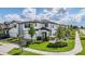 Two-story home featuring white walls, a brick driveway, and lush landscaping at 7517 Notched Pine Bnd, Wesley Chapel, FL 33545