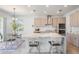 Open-concept kitchen featuring a large island with bar seating and modern stainless appliances at 7517 Notched Pine Bnd, Wesley Chapel, FL 33545