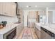 The kitchen features light wood cabinets, stainless steel appliances, and a charming farmhouse sink at 7517 Notched Pine Bnd, Wesley Chapel, FL 33545