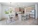 Modern kitchen with stainless steel appliances, a center island, and a cozy breakfast nook at 7517 Notched Pine Bnd, Wesley Chapel, FL 33545