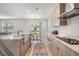 Open kitchen showcases light wood cabinets, stainless appliances, and backyard access to a dining area at 7517 Notched Pine Bnd, Wesley Chapel, FL 33545