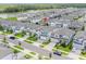 Aerial view of homes in a suburban neighborhood near a lake at 7700 Bronze Oak Dr, Wesley Chapel, FL 33545