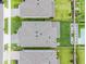 Aerial view of a home showcasing its roof, landscaping, backyard, and proximity to other houses in the neighborhood at 7700 Bronze Oak Dr, Wesley Chapel, FL 33545