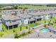 Aerial view of the backyard featuring a screen porch, pool, and landscaped yard at 7700 Bronze Oak Dr, Wesley Chapel, FL 33545