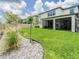 Picture of the spacious backyard with enclosed patio and a garden of small trees at 7700 Bronze Oak Dr, Wesley Chapel, FL 33545