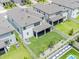 Aerial view of backyard featuring a screen porch, fenced yard, and landscaping at 7700 Bronze Oak Dr, Wesley Chapel, FL 33545